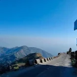 Photo shared by Kaushik Roy in their review: a hill road winding past mountains under a clear blue sky