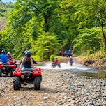 Photo shared by Somya Tiwari in their review: quad bikes on a gravel trail through green forest